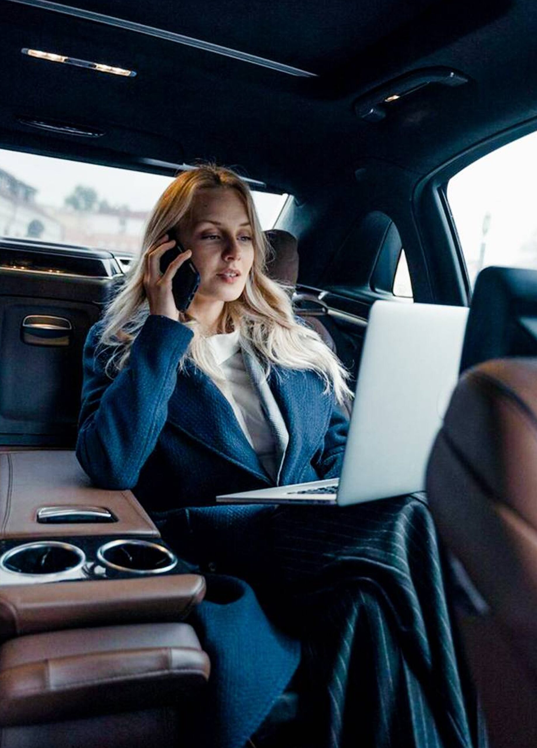 Luxury chauffeur driven car interior with professional passenger