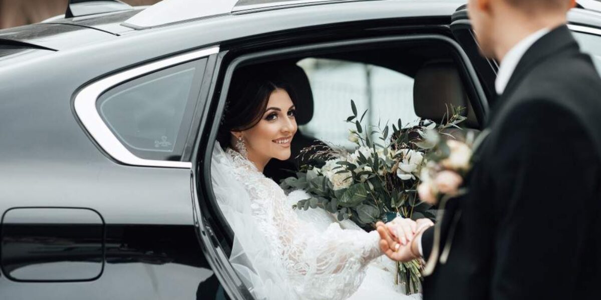 Bride smiling in wedding car – HotWheelz wedding transportation